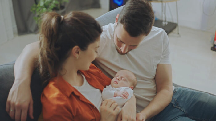 Parents Holding Baby in the Living Room